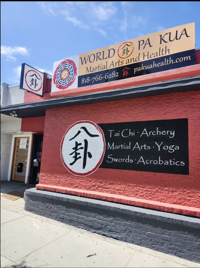 World Pa Kua storefront with rooftop sign, blade sign, and wall graphics
